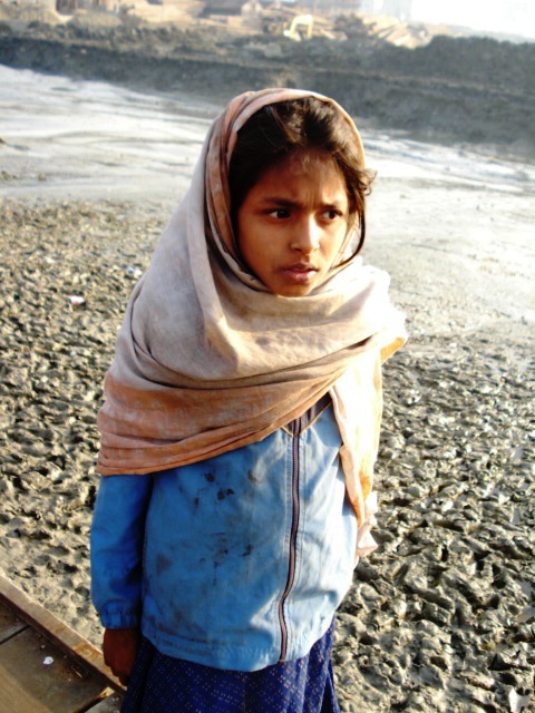  This is a picture of a girl who is a child labor. To support her family, she works in a fish market named Fringe Bazaar in Chittagong, Bangladesh. She has to carry the heavy baskets of fish and get only 10 taka per basket. She cannot carry more than 10 to 12 baskets per day, so at the end of the day she gets only 100 to 150 taka which is less almost 1 or 2 dollars. Most of the time, she does not get any basket to carry as there are other boy child labors who get the first preference for working. 